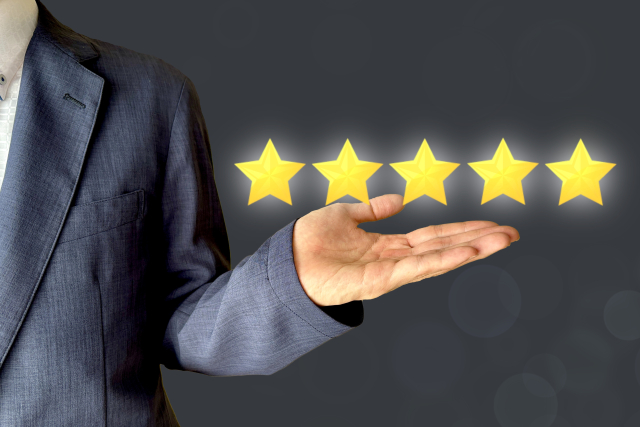 5つ星の評価を手のひらで示すビジネスマンのイメージ